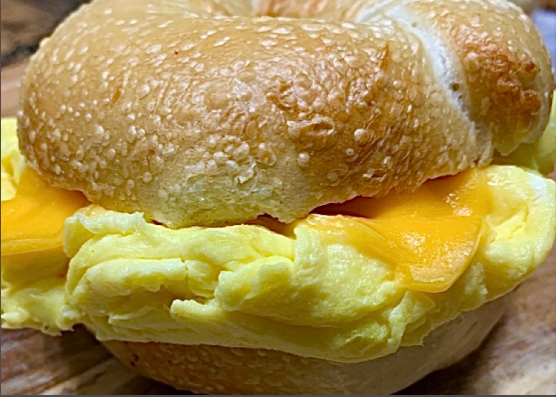 Egg and cheese breakfast sandwich on a sesame bagel
