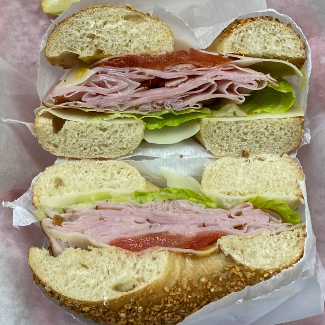 Ham lunch sandwich on a bagel with lettuce and tomato